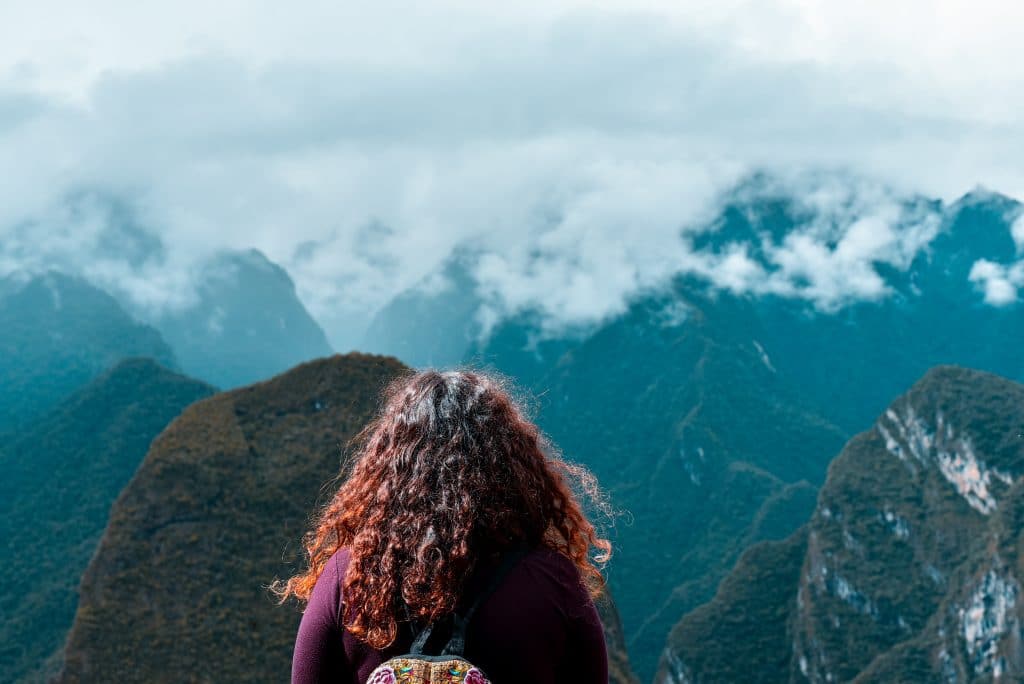 Woman facing mountains