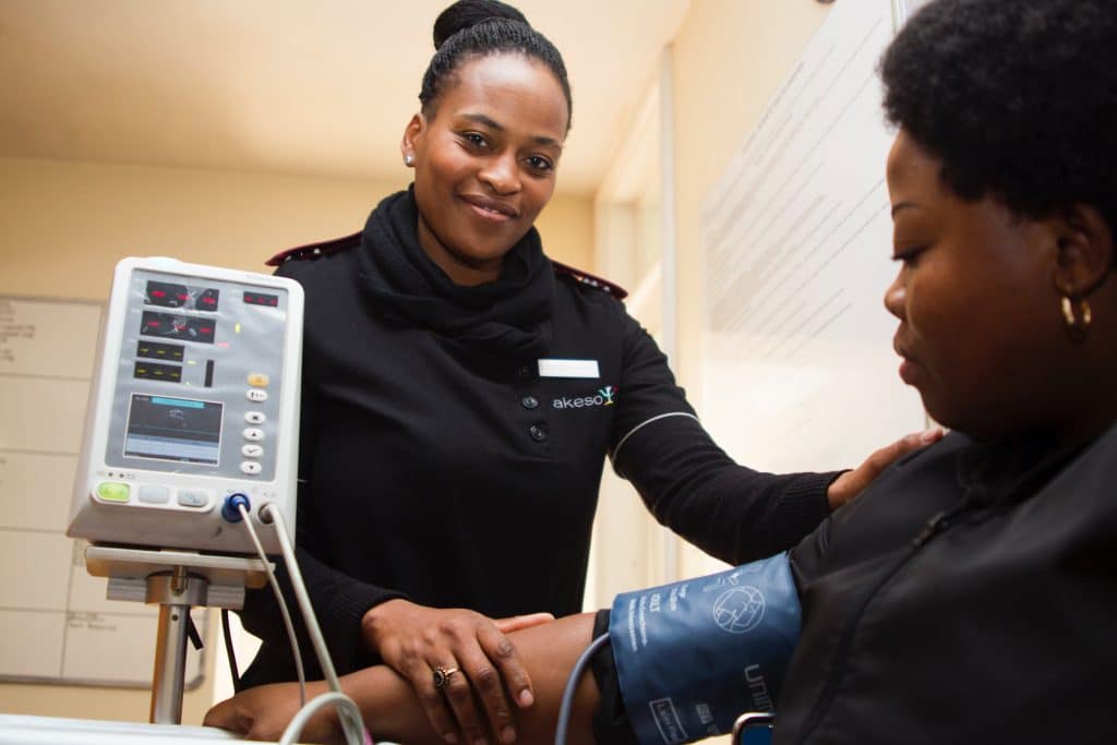 Woman helping blood pressure client