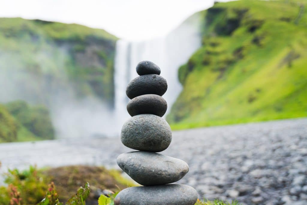 balanced stones with waterfall