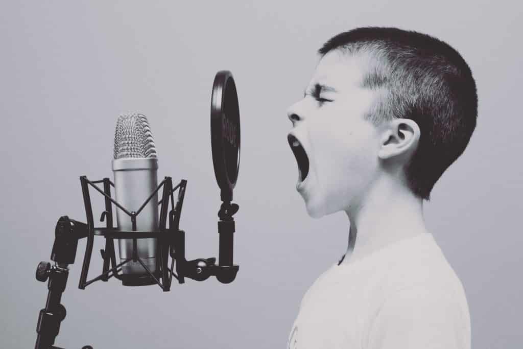 boy singing into mic