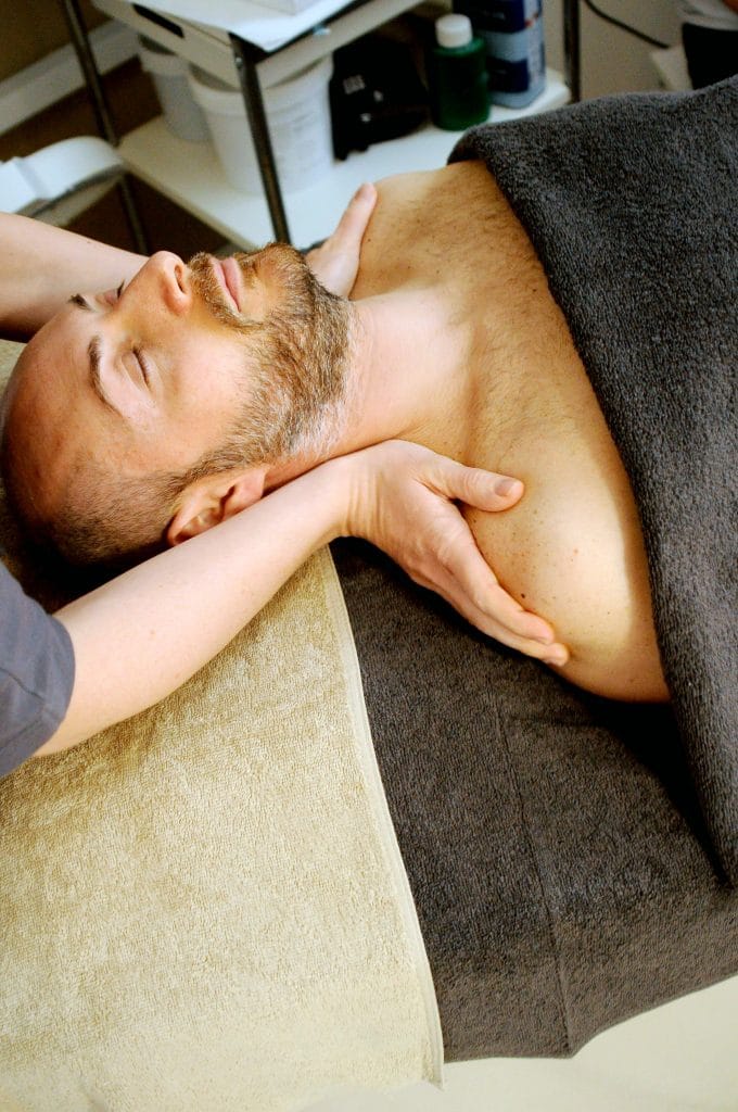 man receiving reiki at spa