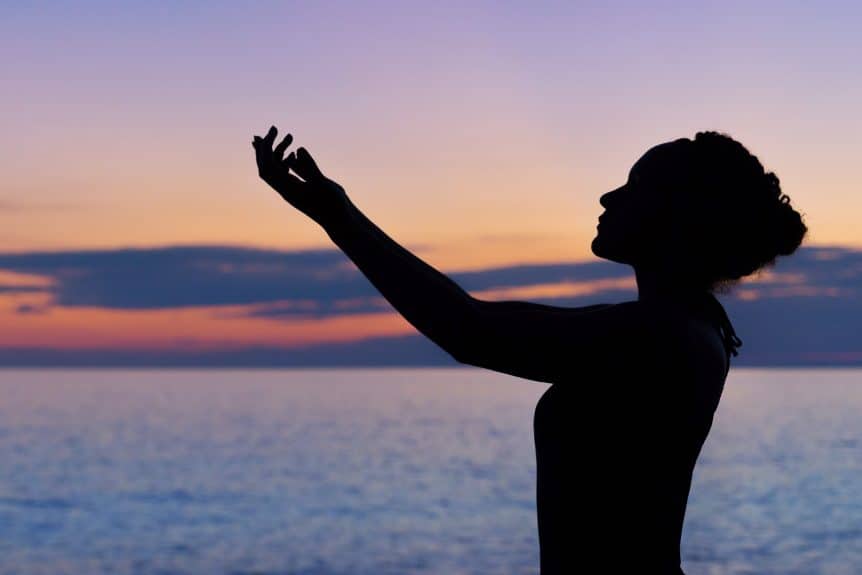 silhoutte of woman raising right hand