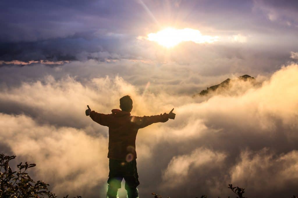 thumbs up above the clouds