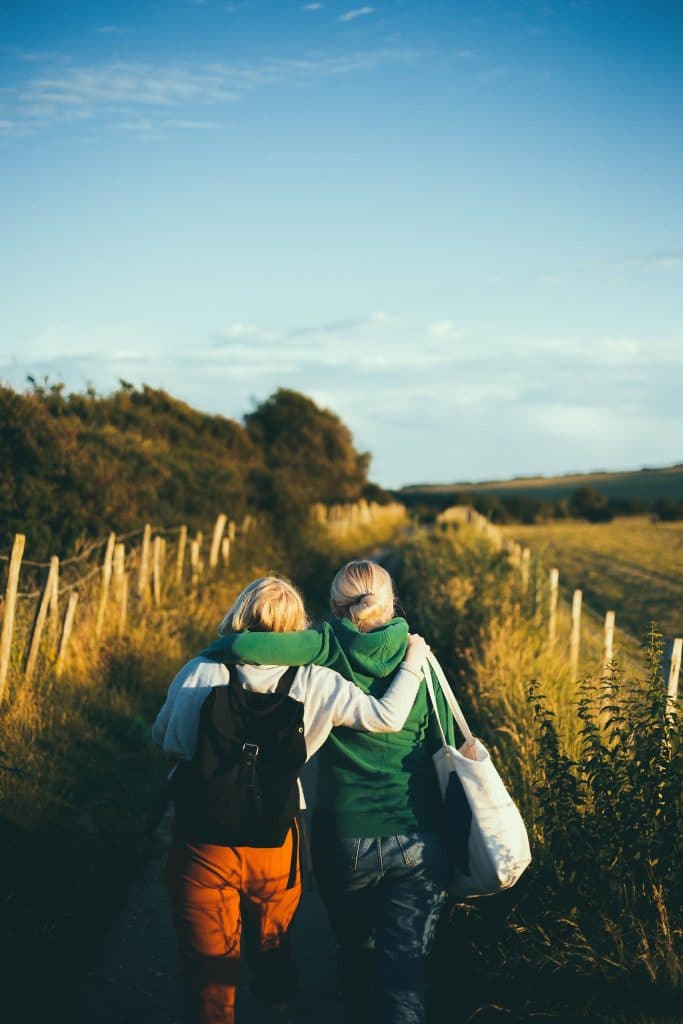 two women walking embracing