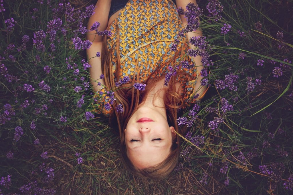 woman sleeping beside flowers