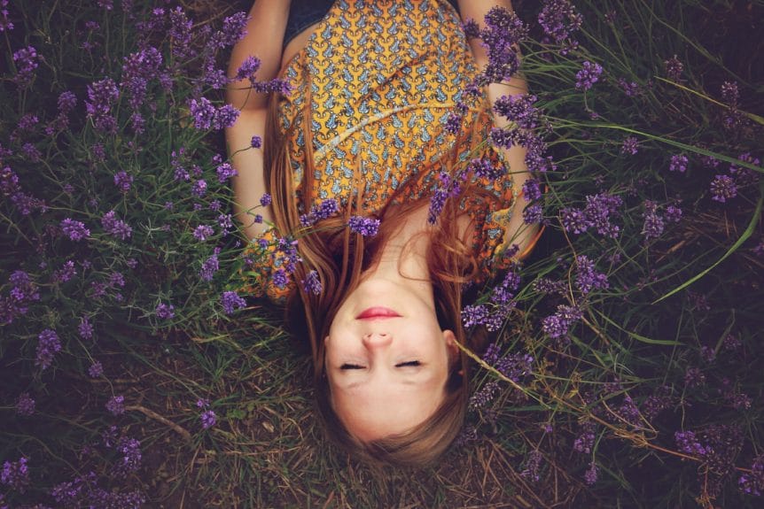 woman sleeping beside flowers