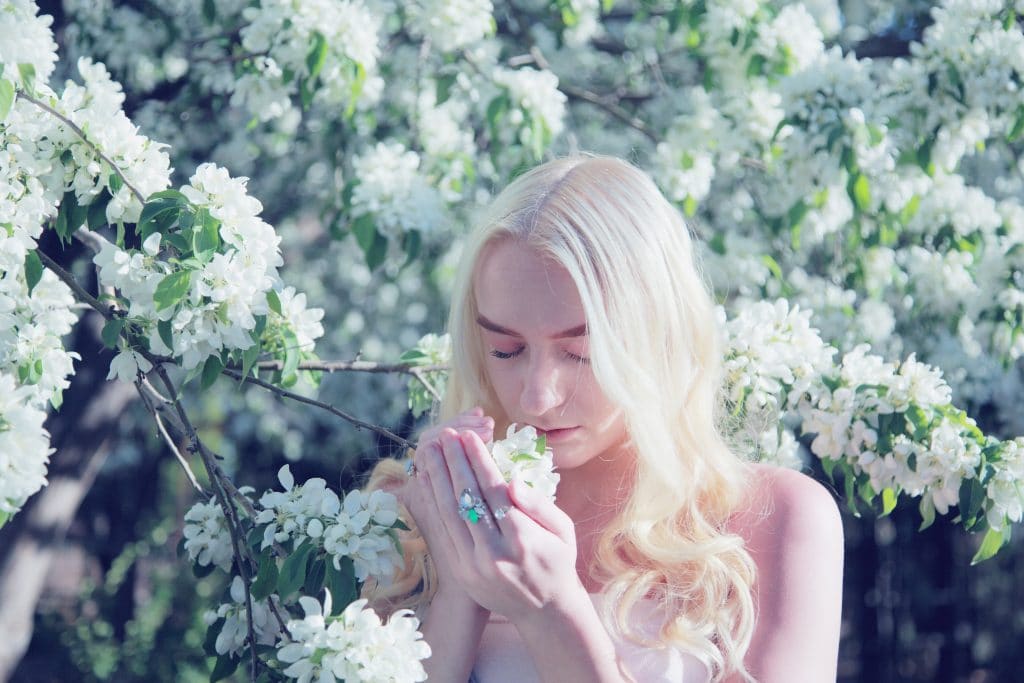 woman smelling flower